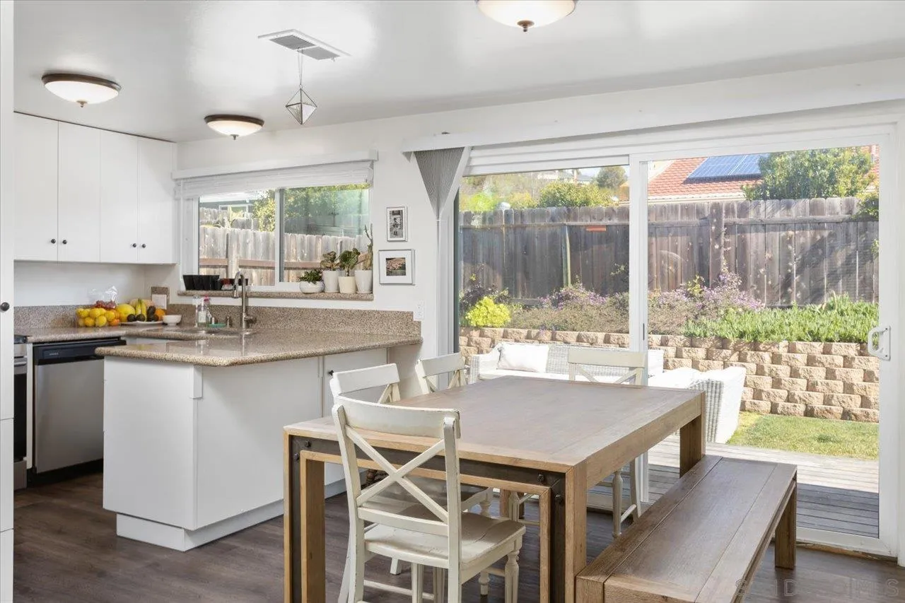 13433 Utopia Road Poway, CA 92064 - Photo 3 of 23 a kitchen with a stove a table and chairs in it