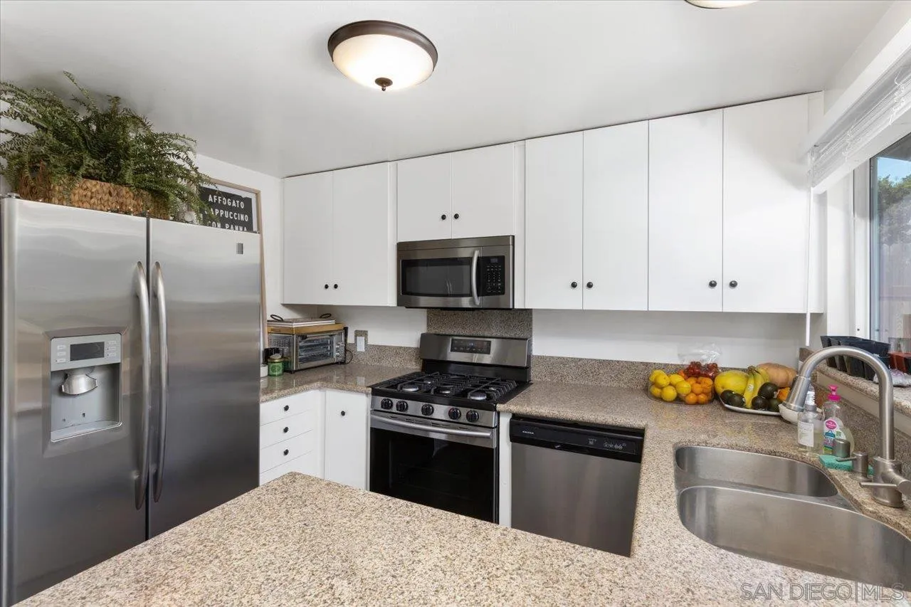 13433 Utopia Road Poway, CA 92064 - Photo 5 of 23 a kitchen with stainless steel appliances granite countertop a sink stove and refrigerator