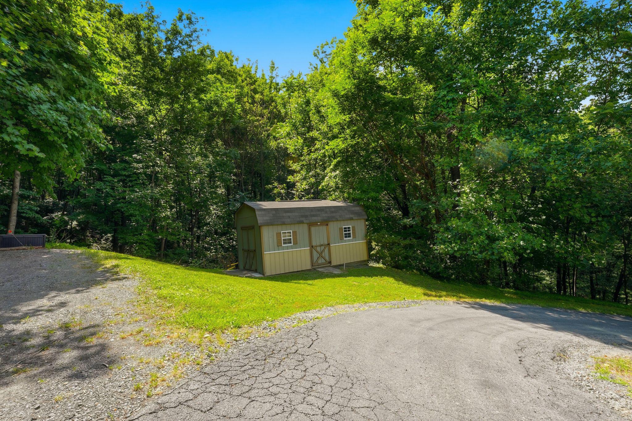 2411 Quaker Run Road Syria, VA 22743 - Photo 44 of 56 Charming shed nestled in lush greenery.