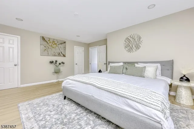 a bedroom with a bed and a painting on the wall