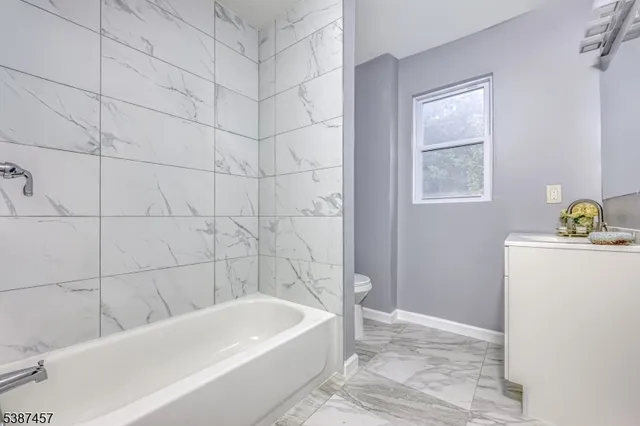 a bathroom with a bathtub and shower
