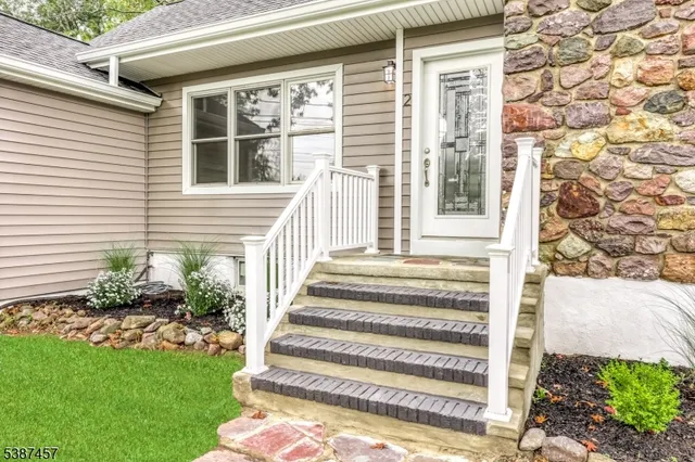 a front view of a house with a garden