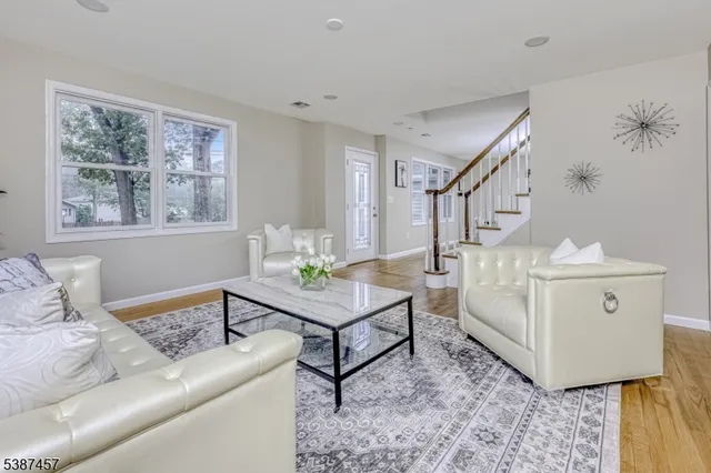 a living room with furniture and paintings on the wall