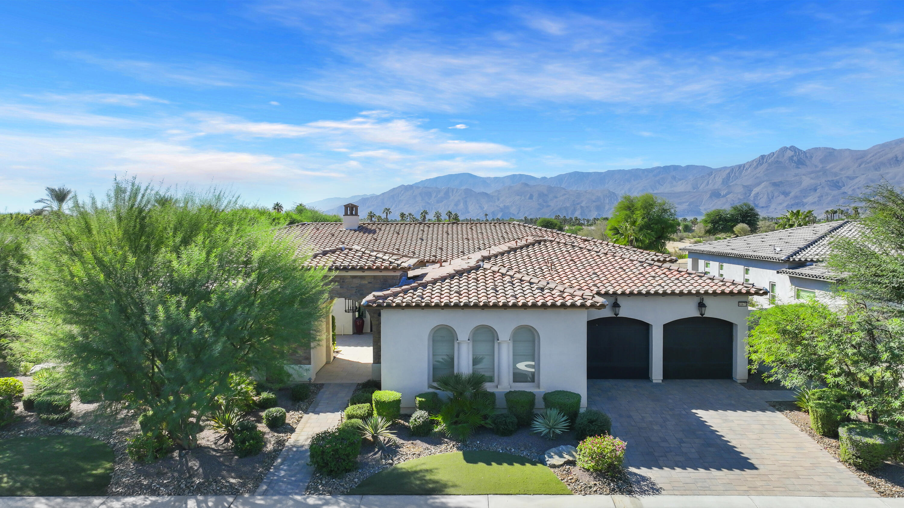 81-675 Thunder Gulch Way La Quinta, CA 92253 - Photo 1 of 61 a front view of a house with a garden