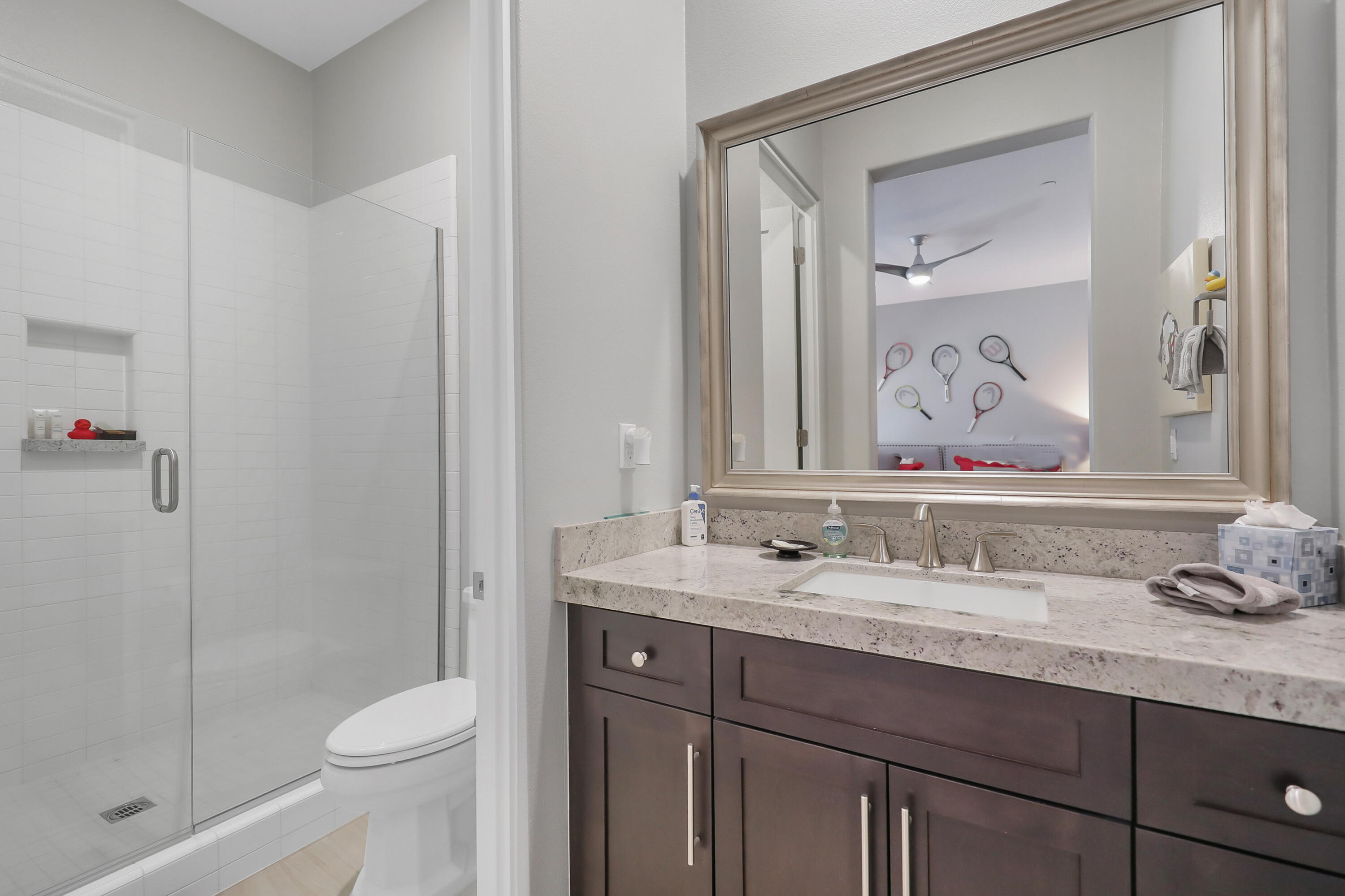 81-675 Thunder Gulch Way La Quinta, CA 92253 - Photo 30 of 61 a bathroom with a granite countertop sink a toilet and a shower