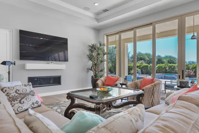 a living room with furniture a flat screen tv and a fireplace