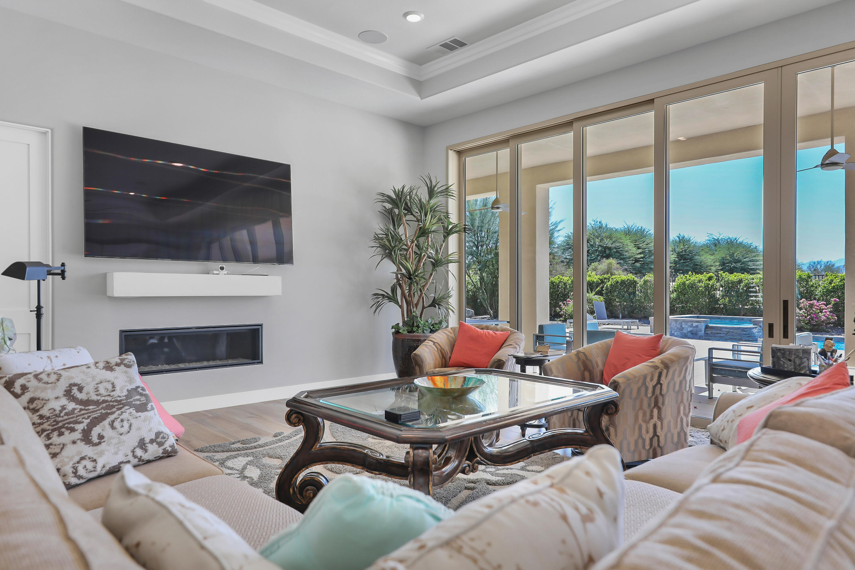 81-675 Thunder Gulch Way La Quinta, CA 92253 - Photo 6 of 61 a living room with furniture a flat screen tv and a fireplace