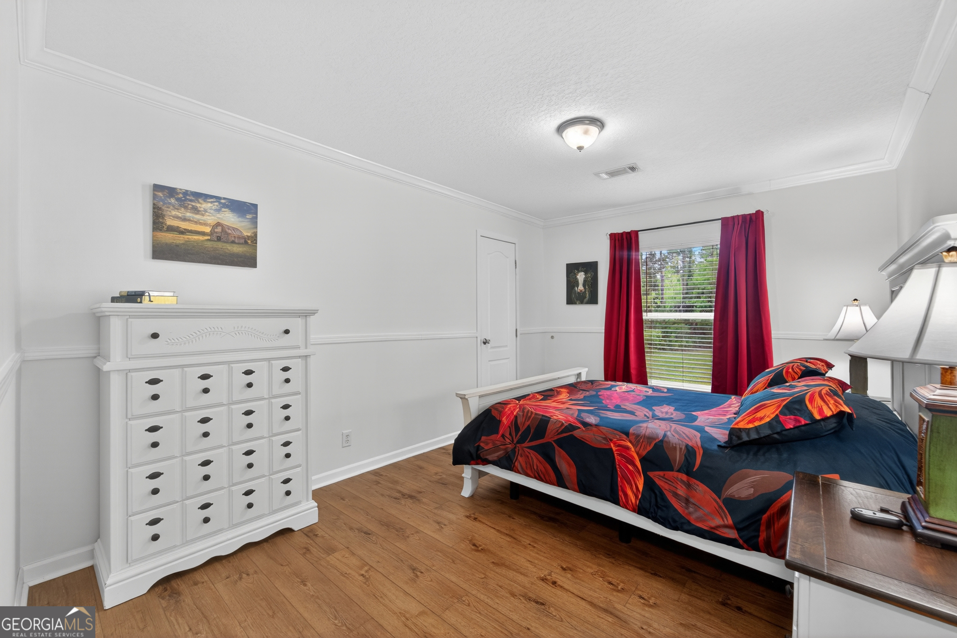 1953 Raybon Road West Hoboken, GA 31542 - Photo 18 of 31 a bedroom with a bed and wooden floor