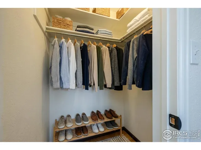 a view of walk in closet with clothes