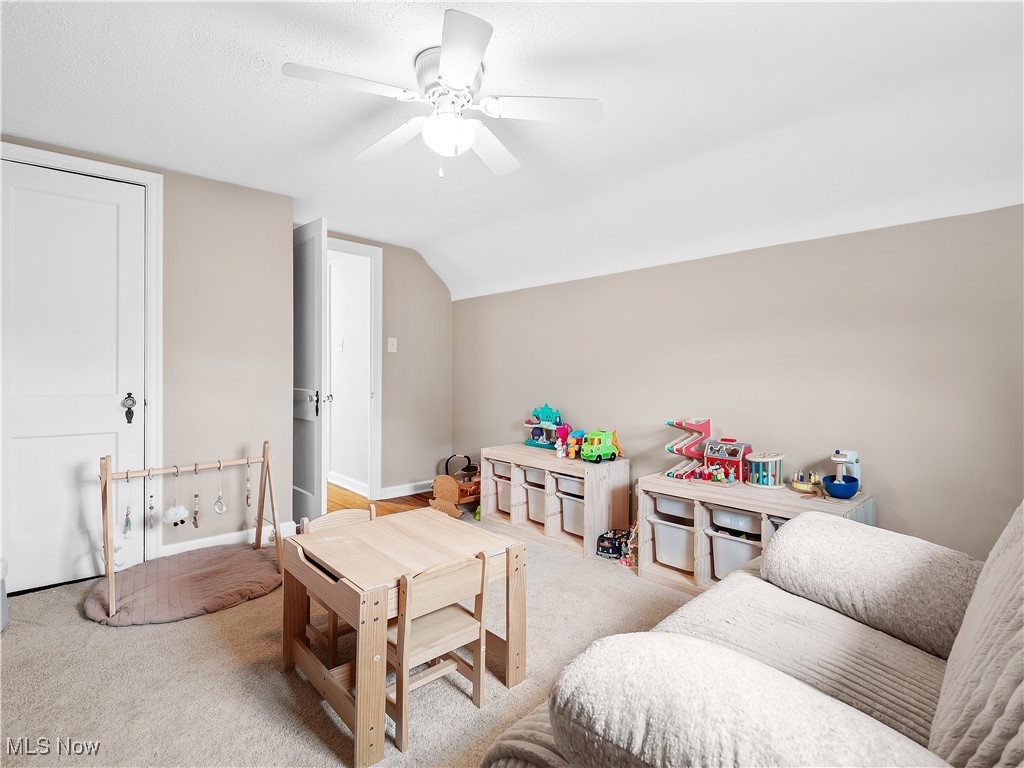 3845 Hillbrook Road Cleveland, OH 44118 - Photo 29 of 38 Recreation room with a ceiling fan, vaulted ceiling, and carpet flooring