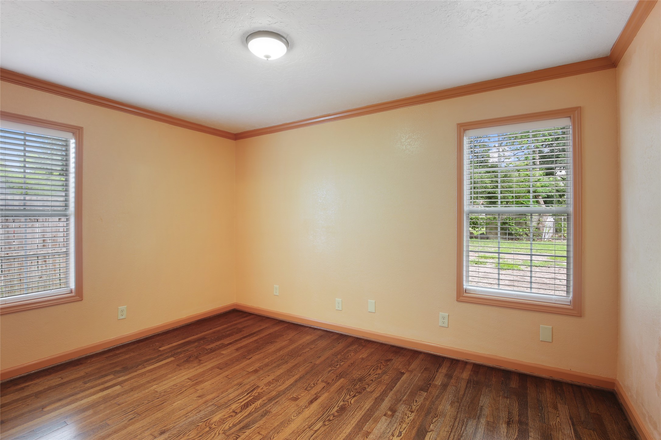 6923 Leader Street Houston, TX 77074 - Photo 7 of 19 an empty room with wooden floor and windows