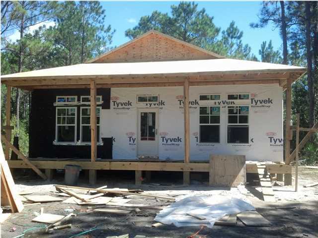X South 4th Street Santa Rosa Beach, FL 32459 - Photo 5 of 7 a front view of a house with a garage