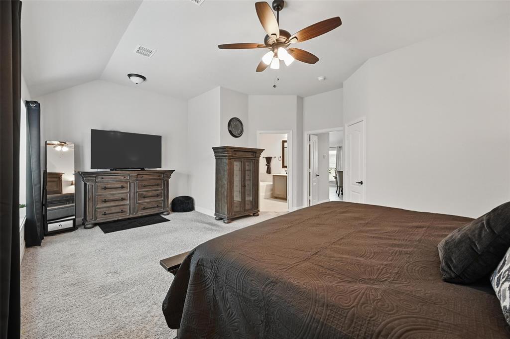 625 Ridgewater Trail Fort Worth, TX 76131 - Photo 11 of 27 Bedroom featuring visible vents, ensuite bathroom, ceiling fan, vaulted ceiling, and carpet flooring