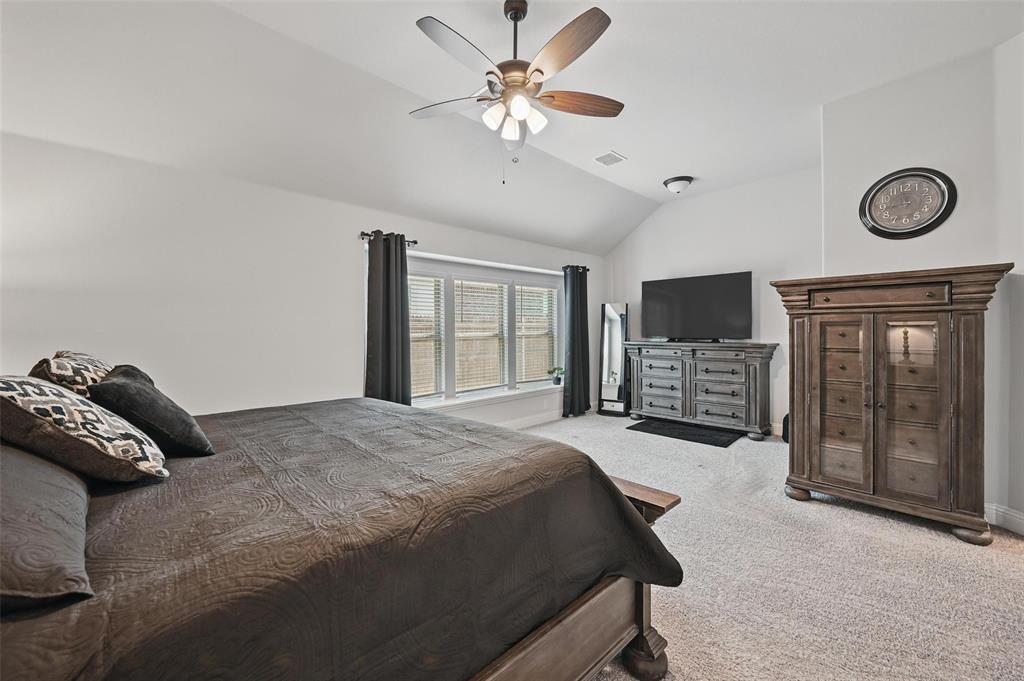 625 Ridgewater Trail Fort Worth, TX 76131 - Photo 12 of 27 Carpeted bedroom featuring visible vents, vaulted ceiling, and a ceiling fan