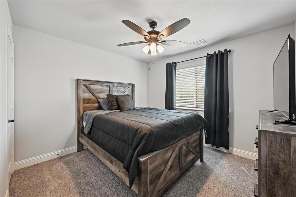 625 Ridgewater Trail Fort Worth, TX 76131 - Photo 15 of 27 Bedroom featuring visible vents, light colored carpet, baseboards, and ceiling fan