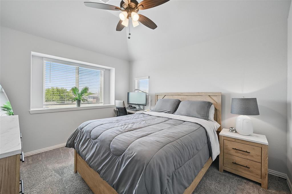 625 Ridgewater Trail Fort Worth, TX 76131 - Photo 17 of 27 Bedroom with dark carpet, baseboards, ceiling fan, and vaulted ceiling