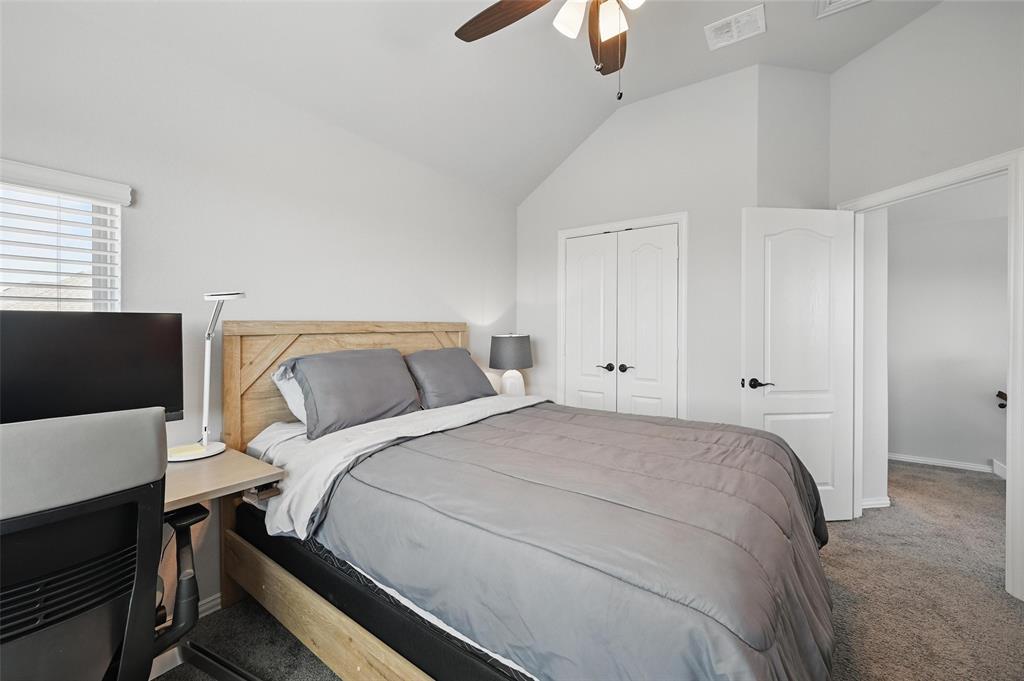 625 Ridgewater Trail Fort Worth, TX 76131 - Photo 18 of 27 Bedroom with a closet, vaulted ceiling, visible vents, ceiling fan, and carpet