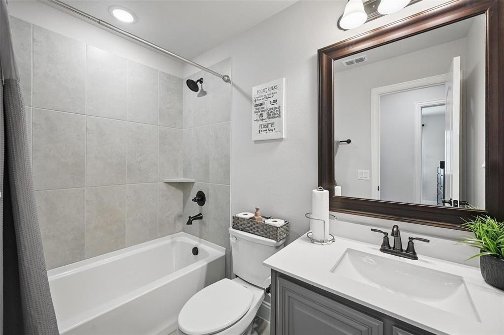625 Ridgewater Trail Fort Worth, TX 76131 - Photo 19 of 27 Full bathroom featuring vanity, shower / bathtub combination with curtain, visible vents, and toilet