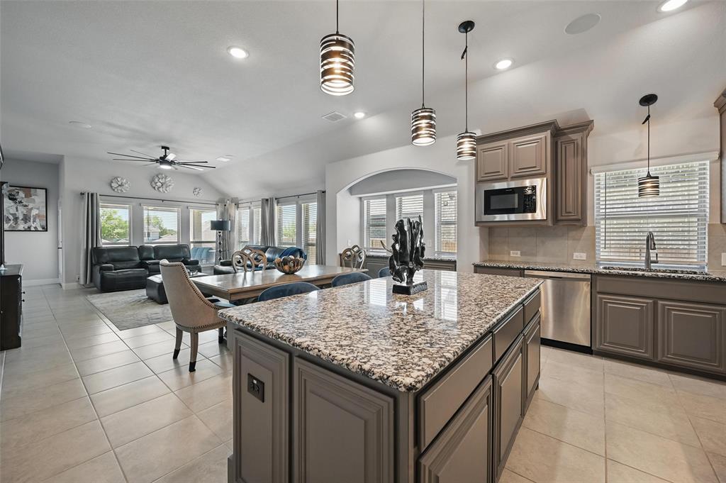 625 Ridgewater Trail Fort Worth, TX 76131 - Photo 4 of 27 Kitchen featuring tasteful backsplash, a ceiling fan, built in microwave, dishwasher, and a sink