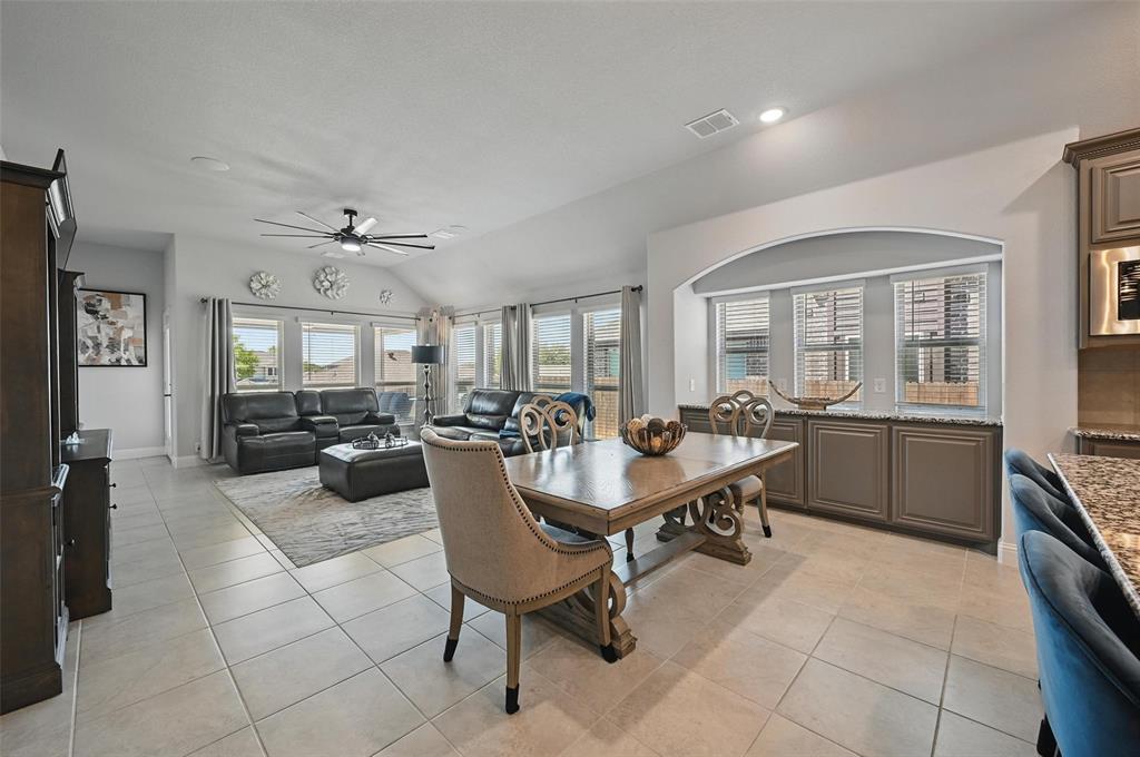 625 Ridgewater Trail Fort Worth, TX 76131 - Photo 6 of 27 Dining room with a wealth of natural light, light tile patterned floors, visible vents, and vaulted ceiling