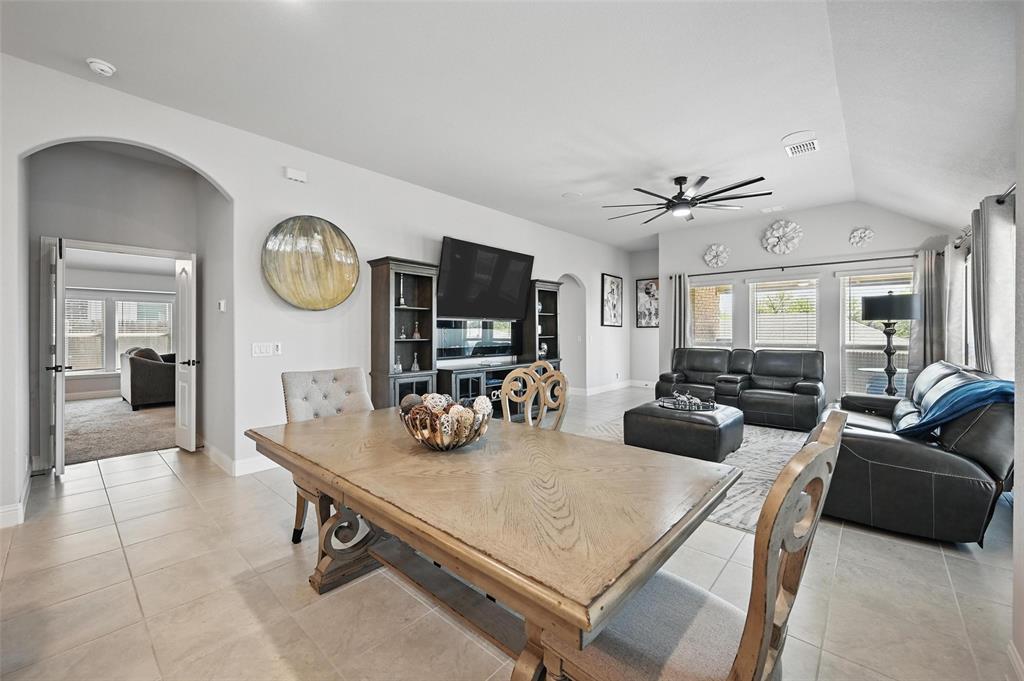 625 Ridgewater Trail Fort Worth, TX 76131 - Photo 8 of 27 Dining room featuring a ceiling fan, arched walkways, lofted ceiling, and a healthy amount of sunlight