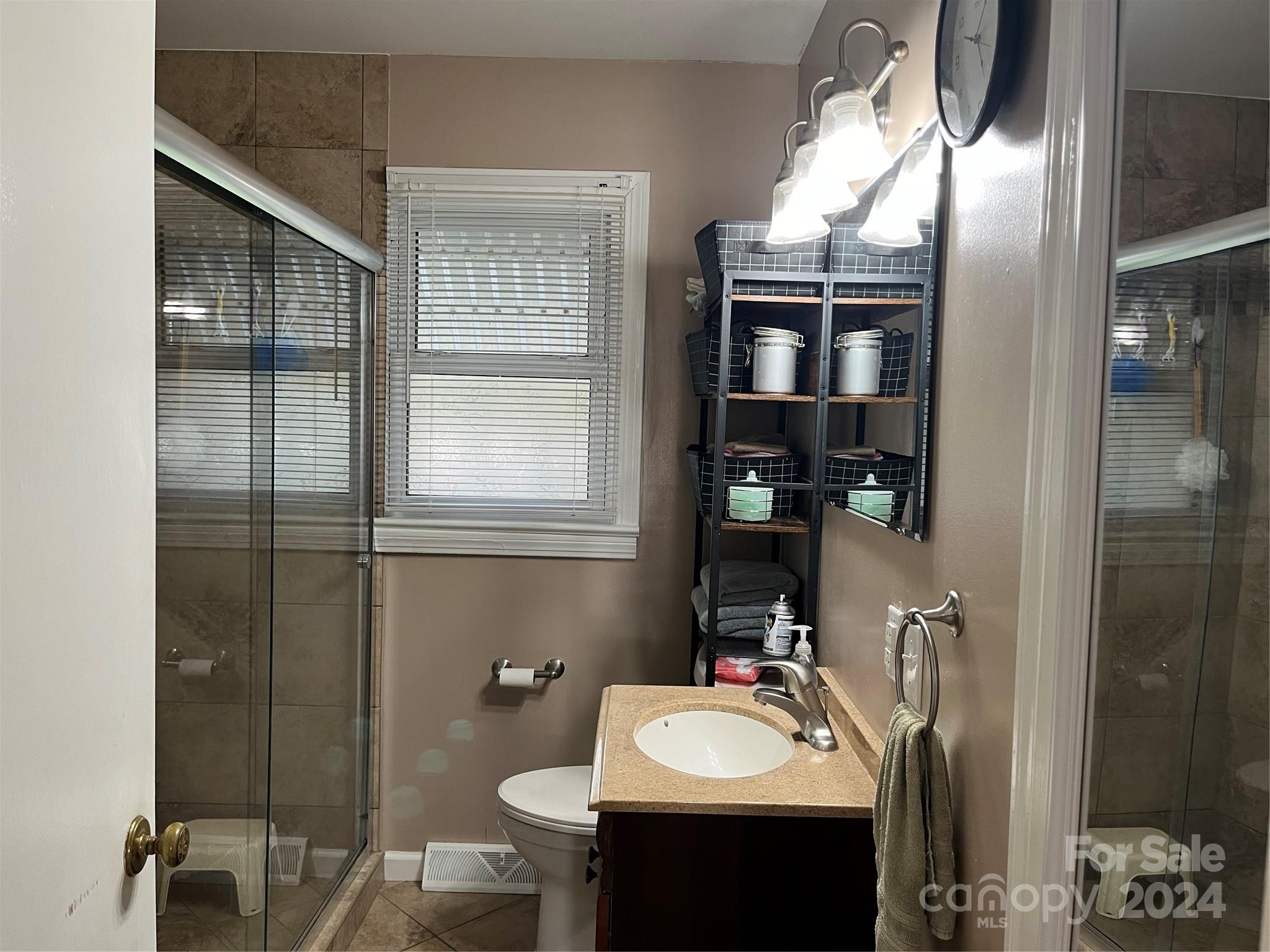 108 North Street Morganton, NC 28655 - Photo 8 of 12 a bathroom with a sink a toilet and shower