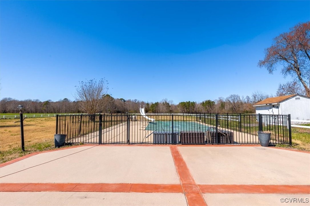 18436 Wakefield Road Courtland, VA 23837 - Photo 47 of 50 View of pool with a gate, a water slide, and fence