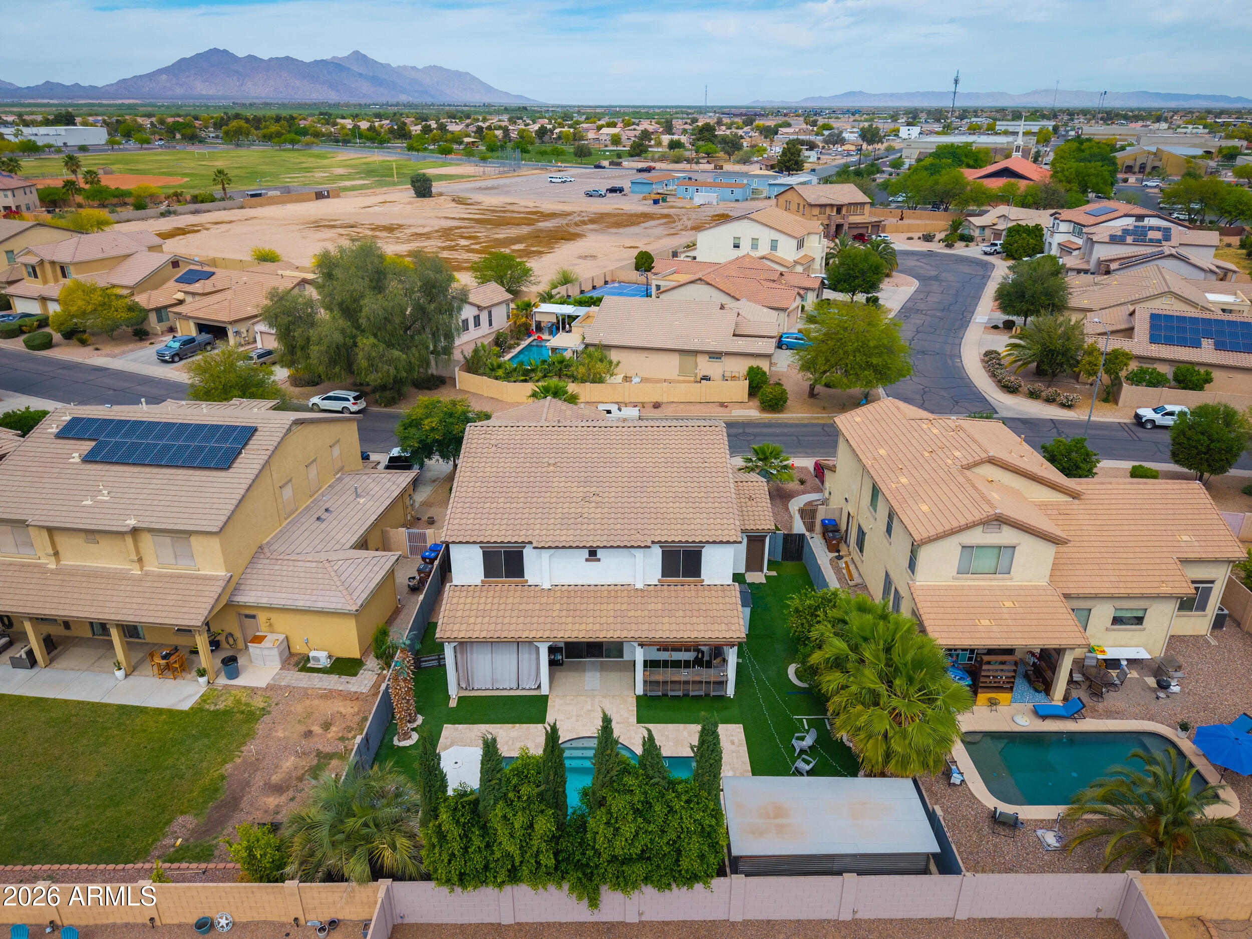 45247 West Jack Rabbit Trail Maricopa, AZ 85139 - Photo 72 of 75 an aerial view of residential houses with outdoor space and swimming pool