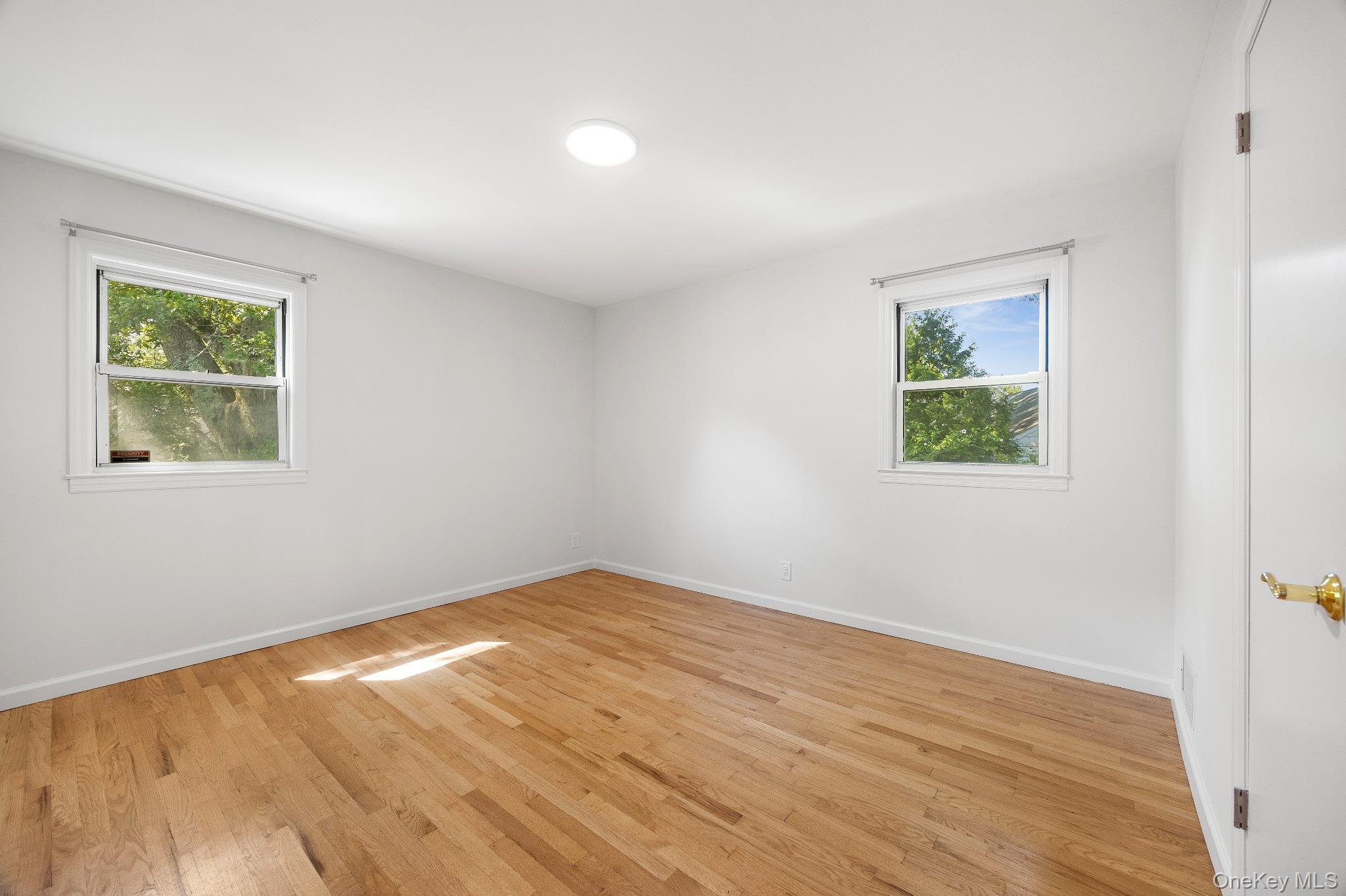 372 Heathcote Road Scarsdale, NY 10583 - Photo 15 of 20 Unfurnished room with light wood-type flooring and baseboards
