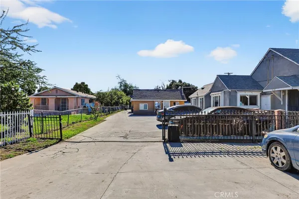 a view of house with a yard and entertaining space