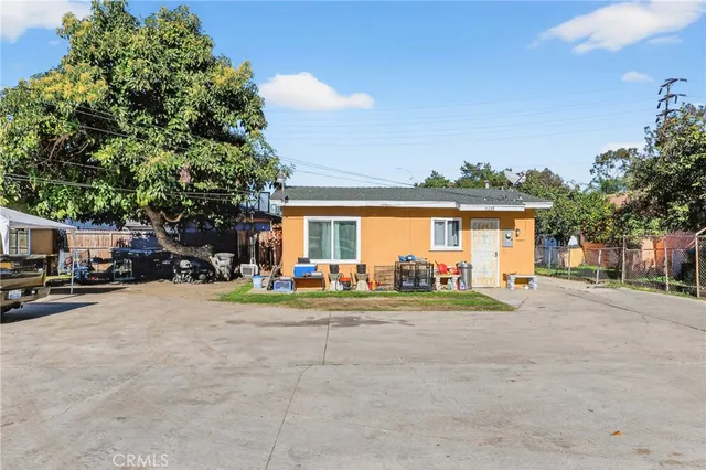 a view of a house with outdoor space and parking
