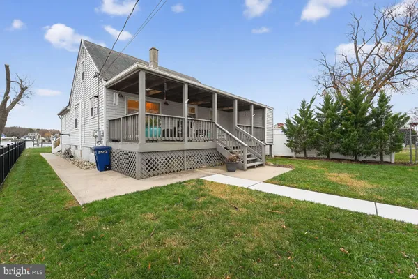 a front view of a house with yard and green space