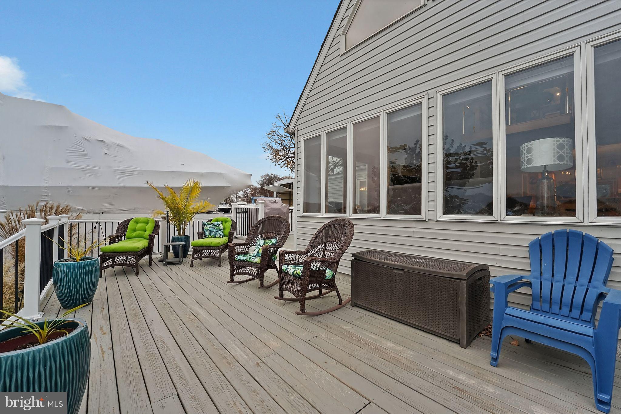 920 Seneca Park Road Middle River, MD 21220 - Photo 25 of 60 a view of a deck with table and chairs with wooden floor and fence