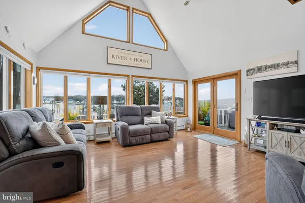 a living room with furniture and a floor to ceiling window