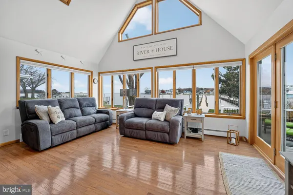 a living room with furniture a ceiling fan and a window