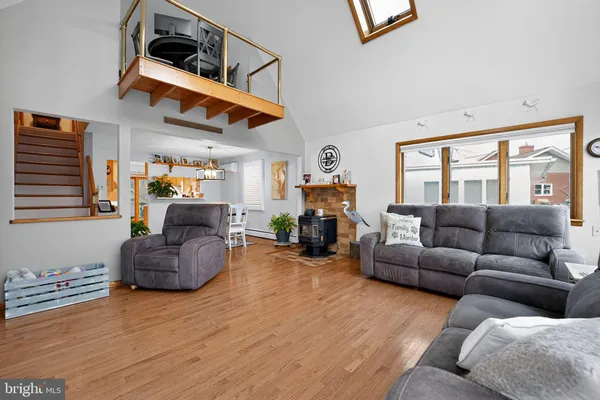 a dining room with furniture potted plants and wooden floor