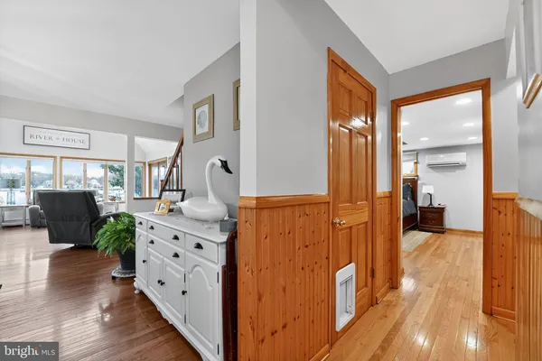 a dining room with furniture potted plants and wooden floor