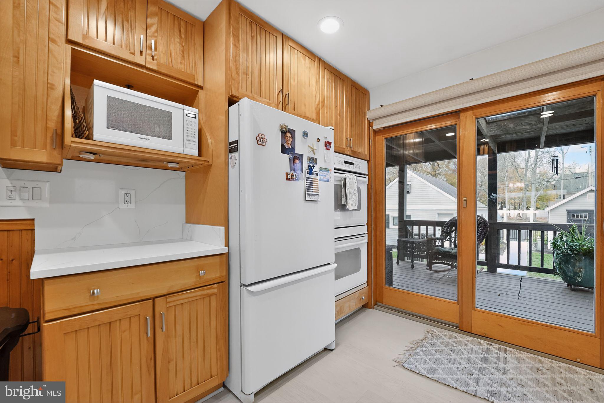 920 Seneca Park Road Middle River, MD 21220 - Photo 36 of 60 a white refrigerator freezer and a stove sitting inside of a kitchen