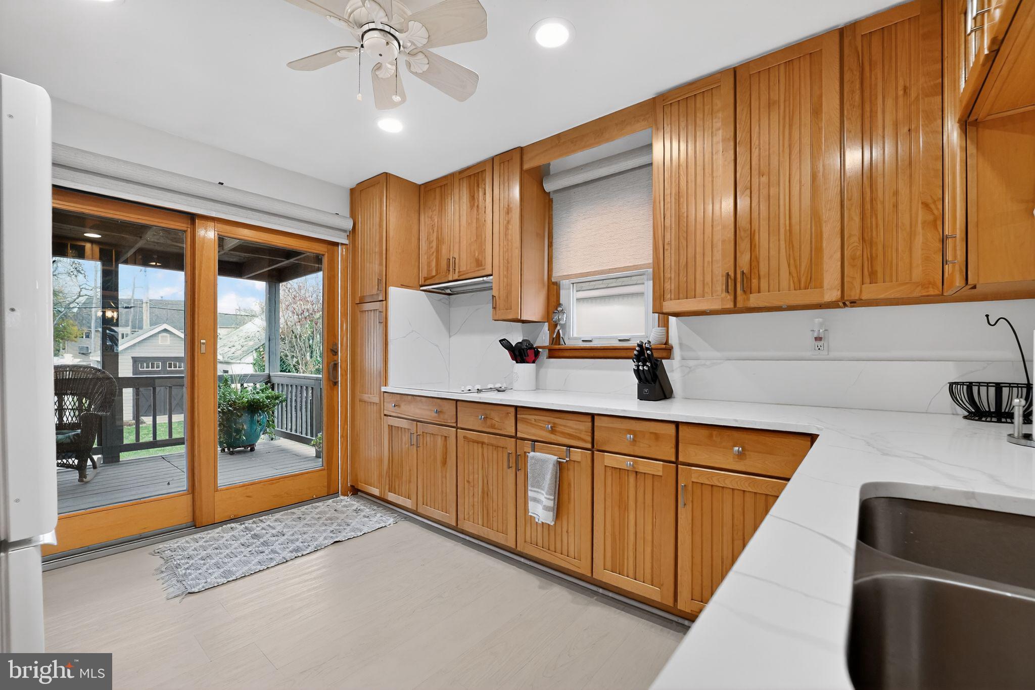 920 Seneca Park Road Middle River, MD 21220 - Photo 37 of 60 a kitchen with stainless steel appliances granite countertop wooden cabinets a stove a sink and a large window