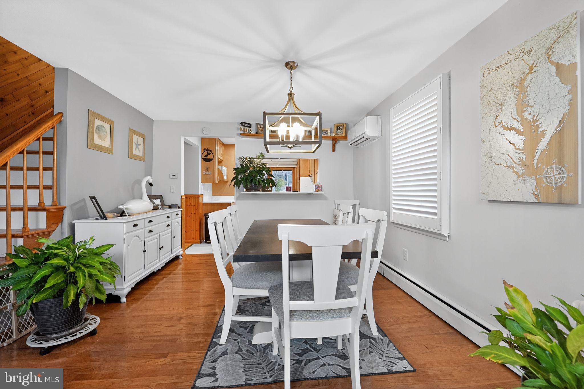 920 Seneca Park Road Middle River, MD 21220 - Photo 42 of 60 a dining room with furniture potted plants and wooden floor
