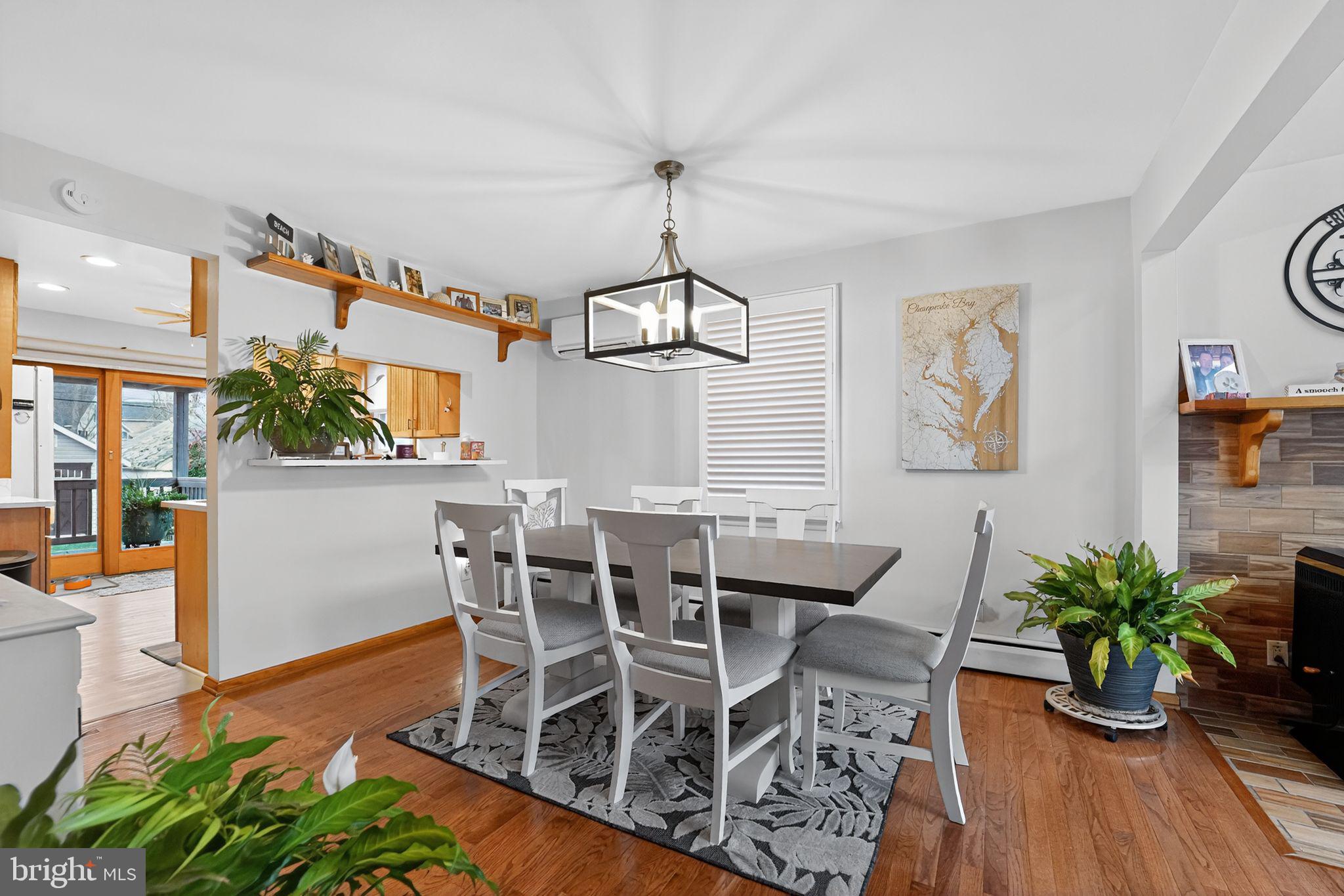 920 Seneca Park Road Middle River, MD 21220 - Photo 43 of 60 a dining room with furniture potted plants and wooden floor