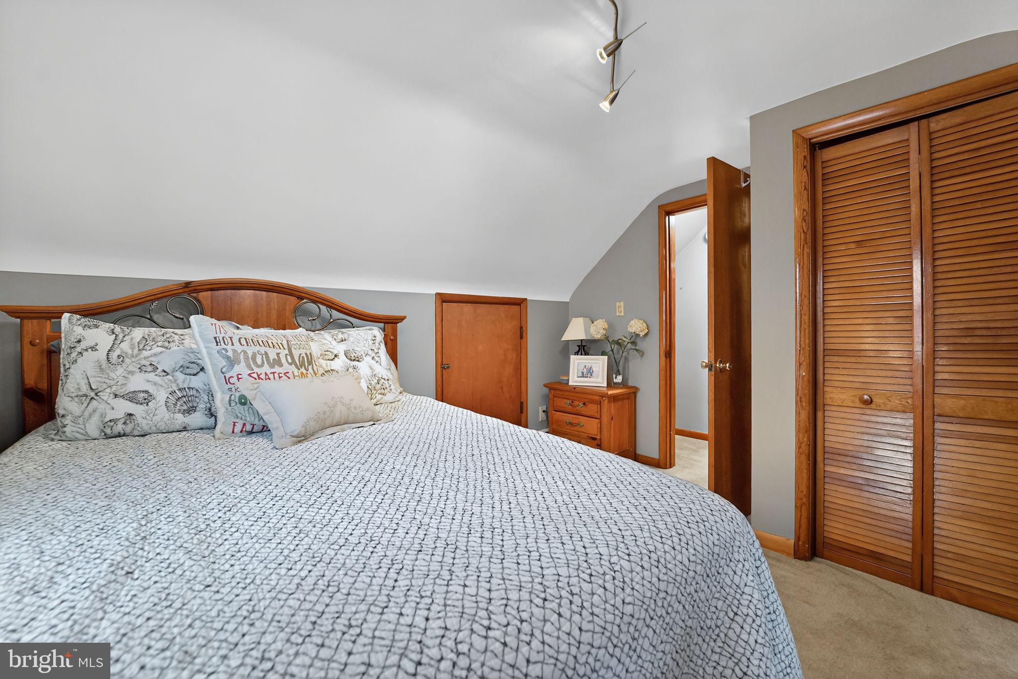 920 Seneca Park Road Middle River, MD 21220 - Photo 58 of 60 a bedroom with a large bed and a large mirror