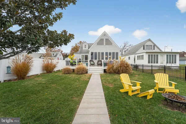 a front view of a house with swimming pool having outdoor seating
