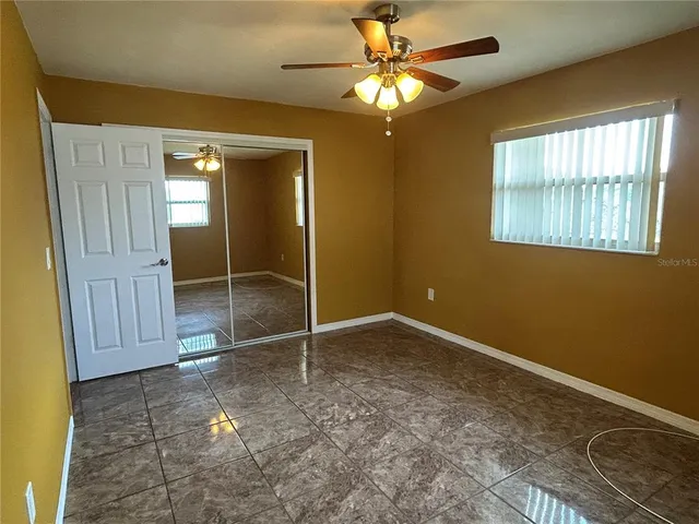 a view of an empty room with a fan