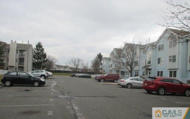 824 Edpas Road, Unit 824 New Brunswick, NJ 08901 - Photo 2 of 11 a view of a street in cars park both side of building