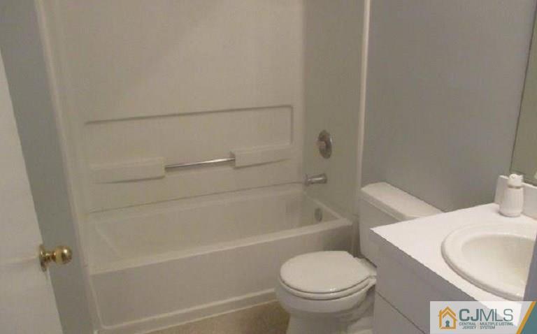 824 Edpas Road, Unit 824 New Brunswick, NJ 08901 - Photo 7 of 11 a white toilet sitting next to a bath tub
