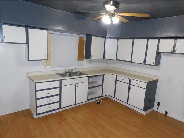 a kitchen with a sink cabinets and appliances