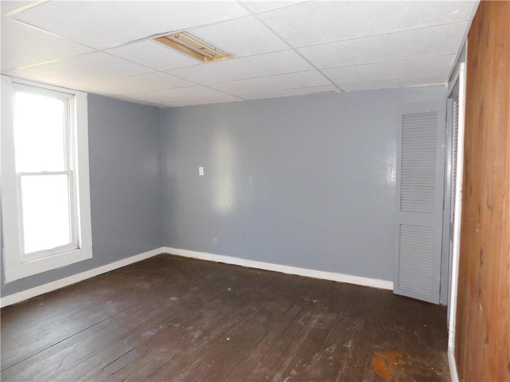 120 Clay Street Uniontown, PA 15401 - Photo 7 of 14 an empty room with wooden floor and windows