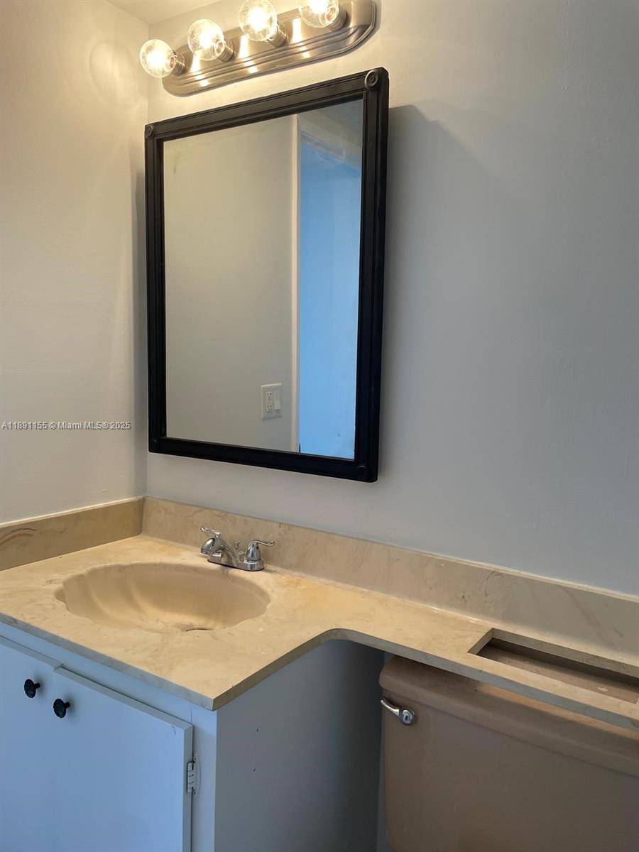 2851 Northeast 183rd Street, Unit 509E Aventura, FL 33160 - Photo 19 of 22 a bathroom with a sink and a mirror