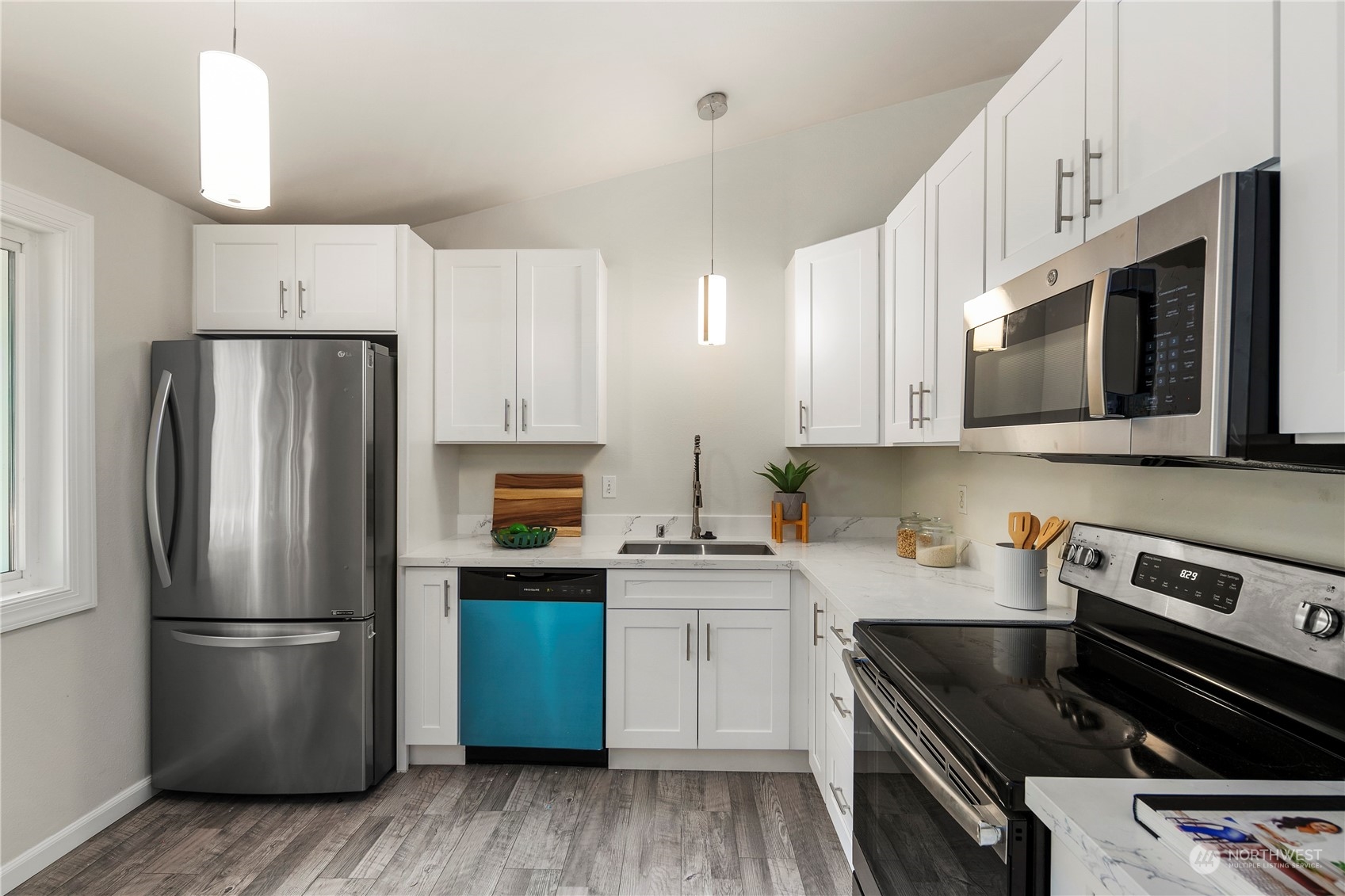 23019 20th Avenue Southeast Bothell, WA 98021 - Photo 11 of 34 a kitchen with stainless steel appliances a refrigerator stove microwave and sink